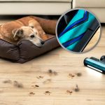 aspiradora sin cable recogiendo pelo de perro junto a su cama